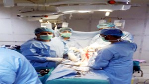 Doctors performing a bilateral knee replacement surgery on old man in GMC Jammu.