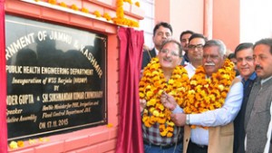 Speaker Legislative Assembly, Kavinder Gupta flanked by Minister for PHE, Sukhnandan Kumar inaugurating WSS at Barjala on Tuesday.