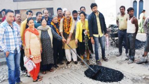 Senior leader BJP, Yudhvir Sethi kick starting black topping at Lajpat Nagar on Wednesday.