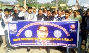 Members of SC/ST Confederation taking out protest rally on Friday.