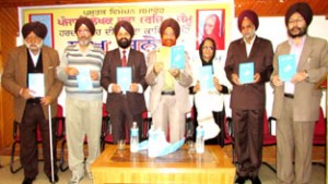 Punjabi book being released during a function at Jammu on Thursday.