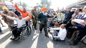 Physically challenged people staging a protest at Dogra Chowk in Jammu on the eve of World Disability Day. -Excelsior/ Rakesh