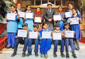 Scouts and Guides of KC Public School displaying certificates while posing for a photograph along with Principal, Amarendra Kumar Mishra after their return from Kolkata.