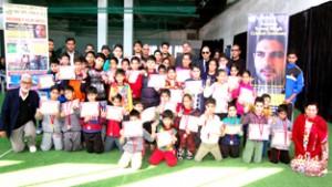 Children holding certificates while posing for a group photograph at KC Sports Club on Sunday.