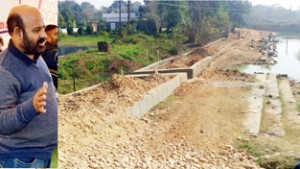 Former Minister & MLA Bali Bhagat inspecting work of pond at Kote on Wednesday.