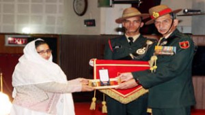 Northern Army Commander Lt Gen D S Hooda awarding medal to a woman on Friday.