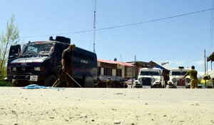 Army and police stand guard to enforce curfew along Kupwara-Baramulla Highway near Handwara on Thursday. —Excelsior/Aabid Nabi