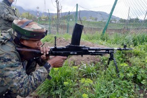 A soldier takes position during encounter with militants in Shopian on Thursday. -Excelsior/Younis Khaliq