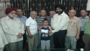 The office bearers of Hari Prabhu Sanstha presenting a cheque to the beneficiary.