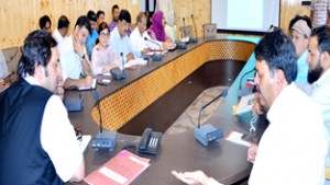 Minister for Social Welfare Sajjad Gani Lone chairing a meeting at Srinagar on Thursday.