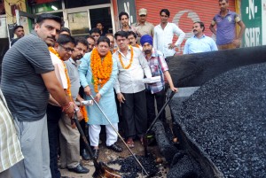 Rajesh Gupta, Jammu East MLA during blacktopping work of road on Sunday.