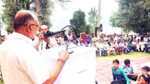 MLA Chenani Dina Nath Bhagat addressing public meeting at Dudu on Friday.