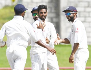 Bhuvneshwar Kumar (C) celebrates with Ajinkya Rahane (R) of India taking 5 West Indies wickets for 33 runs during day 4 of the 3rd Test between West Indies and India on August 12, 2016 at Darren Sammy National Cricket Stadium Gros Islet, St. Lucia. / AFP / Randy BROOKS (Photo credit should read RANDY BROOKS/AFP/Getty Images)