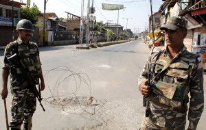 Security personnel stand guard to enforce curfew at Hawal area of Srinagar on Friday.     —Excelsior/Shakeel
