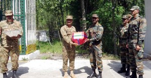 Indo-Pak Army officials exchange sweets at LoC in Poonch on Tuesday.