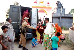 Security personnel shift border villagers in a bullet-proof bunker from Bobiya in Hiranagar sector on Friday.    -Excelsior/ Madan