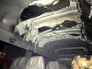 A tempo traveller damaged in a petrol bomb attack at Eidgah, Srinagar on Friday.     -Excelsior/ Shakeel