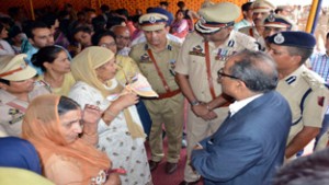 DyCM Dr Nirmal Singh and IGP Jammu Danish Rana interacting with family members of Police martyrs on Friday.