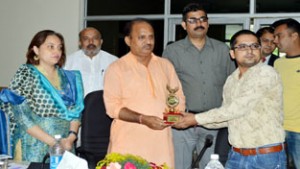 MLA Samba Dr Davinder Kumar Manyal presenting trophy to an entrepreneur at Samba on Saturday. Also seen in the picture is DDC Samba Sheetal Nanda.