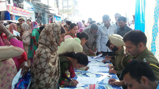 People filling forms of special counter installed by Samba outside JK Bank.