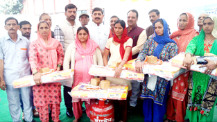 MP Jugal Kishore and MLA Rajiv Sharma distributing LPG connections to BPL families at Akhnoor on Tuesday.