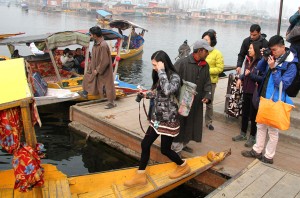 Foreign tourists enjoy Shikara ride on Dal lake waters as tourist arrival picks up again after unrest in Valley. —Excelsior/Shakeel