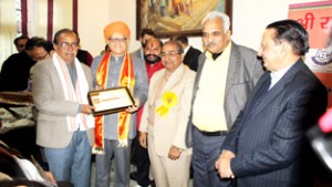President, J&K Dharmarth Trust, B R Kundal felicitating a dignitary at Jammu.