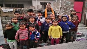 Social activist, Rampaul Dogra posing with child artists after staging nukkad ‘Bachon Ki Awaaz’ at Chimma Chak in Bishnah.