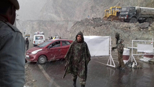 Traffic Police authorities close Mughal Road after heavy snowfall at Pir Panjal on Monday.