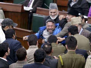Congress MLA from Kargil Haji Asgar Ali Karbalaie being marshaled out in the Assembly as other MLAs try to protect him on Wednesday. —Excelsior/Rakesh