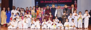 Children posing alongwith chief guest and other dignitaries while celebrating 5th Annual Day  at SKV International Playway School. 