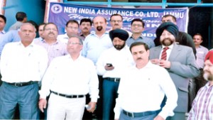 Chief Regional Manager, New India Assurance, P K Jain, Regional Manager, Dr Ramesh Pandita and Divisional Manager G S Bali after inauguration of new office of the company at Vijaypur posing for a photograph.