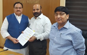 Health & Education Minister Bali Bhagat handing over list of various issues to Union Minister J P Nadda at New Delhi. 