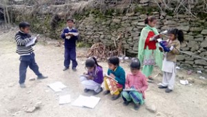 Students of GHS Poneja studying under open sky.  —Excelsior/Tilak Raj