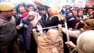 Police cane-charging MGNREGA employees in Srinagar.  — Excelsior/Shakeel