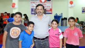 Winners posing for a group photograph along with former ace peddler at Stag TT Academy in Jammu on Sunday.