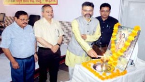 Senior journalist Prafull Ketkar lighting lamp in front of a portrait of Maharishi Narad during a function at Jammu on Thursday.