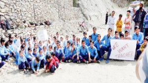 Students of Government High School Galigadh protesting by blocking Kishtwar-Sarthal road.