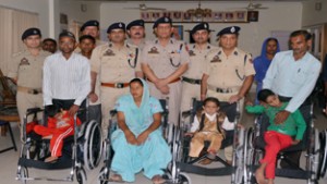Physically challenged persons posing for a photograph after receiving wheel chairs on Thursday.