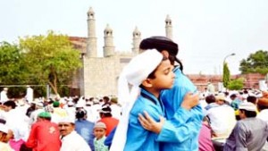 Children exchanging Eid greetings during prayers at Jammu on Monday.-Excelsior/Rakesh