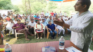 MLA Ramnagar, R S Pathania, addressing gathering in his constituency on Monday.