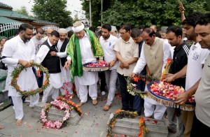 NC president Farooq Abdullah paying floral tributes to 1931 martyrs in Srinagar on Thursday. -Excelsior/Shakeel