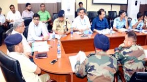 Div Com, Dr Mandeep K Bhandari chairing a meeting at Jammu on Friday.