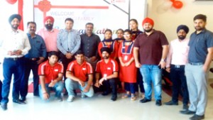 MD TS Sahni and staff of  Hero MotoCorp Ltd at inauguration of new Devika Automobiles showroom  at Greater Kailash Chowk in Jammu on Thursday. 