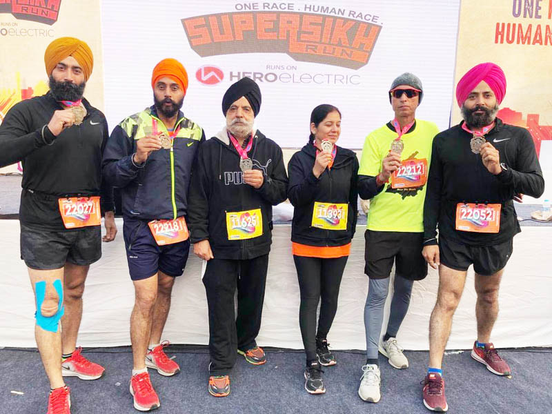 Rajesh Padha and other members of Jammu Runners Group posing with their