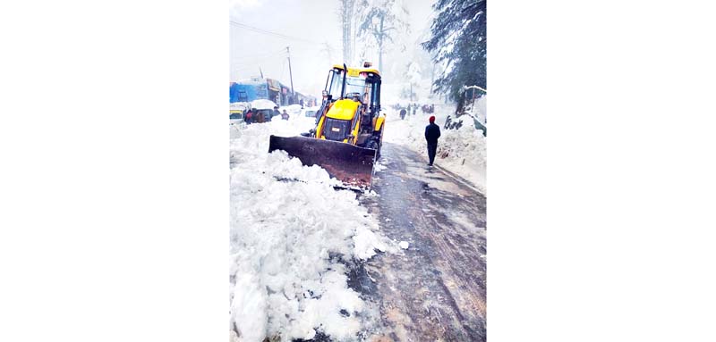 Snow clearance work in progress at Patnitop. -Excelsior/Parvez Mir