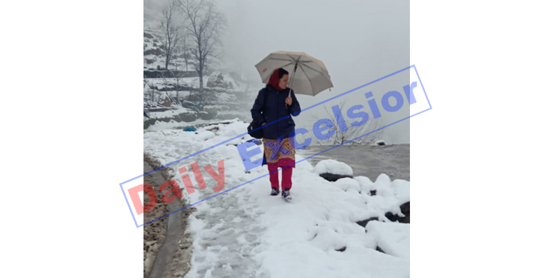 A woman moves on fresh snow in Bhaderwah on Saturday. —Excelsior/Tilak Raj