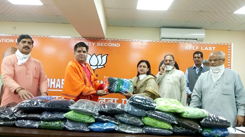 J&K BJP Secretary Rekha Mahajan handing over face masks to BJP leaders at Jammu.