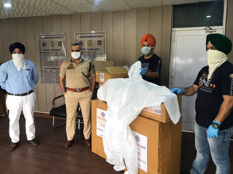 Khalsa Aid handing over full body kits, masks and sanitizers to SSP Samba Shakti Pathak.