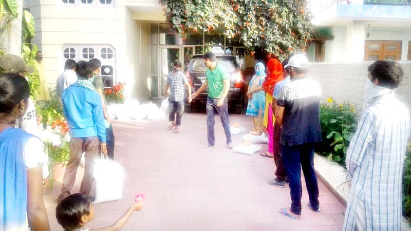 Youth Congress President J&K Uday Bhanu Chib distributing ration kits to needy people in Paloura area of Jammu. 